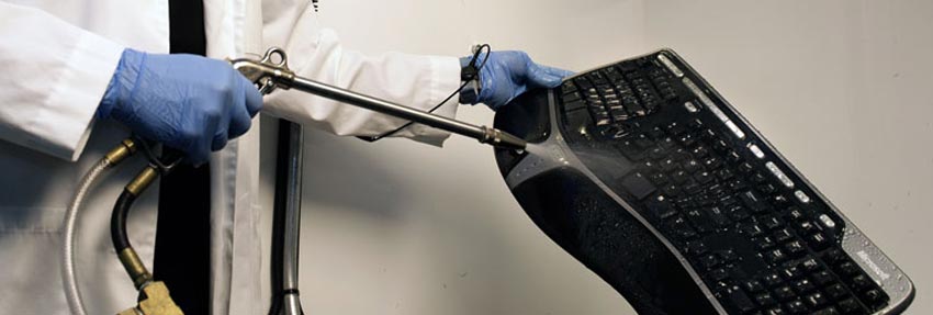 a keyboard being cleaned by a contents technician