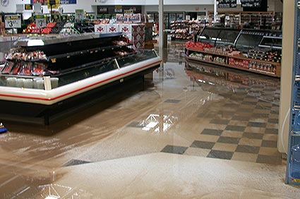 the deli of a grocery store with an inch of mud and water covering the floor